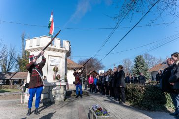A Békés Megyei Károlyi-huszár és Honvéd Hagyományőrző és Kulturális Egyesület két tagja sortüzet lő az ünnep tiszteletére Csabacsűdön 2026. március 15-én.